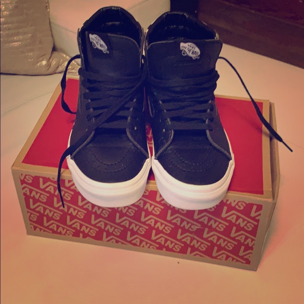 Black and white high top Vans